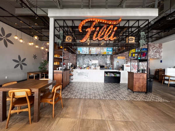 FiLLi Cafe Sugar Land Texas with neon FiLLi sign and brick counter